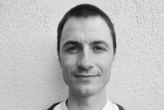 A male researcher in front of a wall